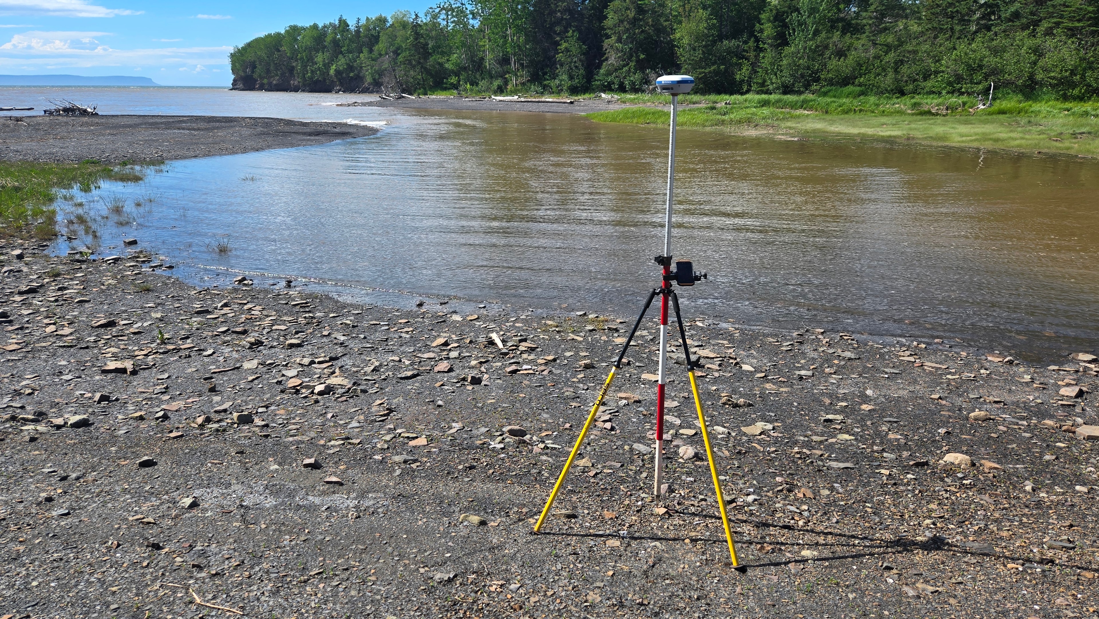 GNSS rover on bipod on snowy hillside with pink flagging